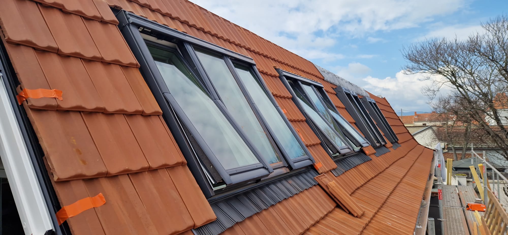 Pose de série de Velux — toiture tuiles en cours